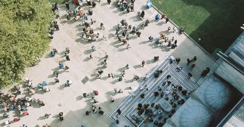 Overhead view of people moving through a busy university campus courtyard.