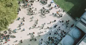 Overhead view of people moving through a busy university campus courtyard.